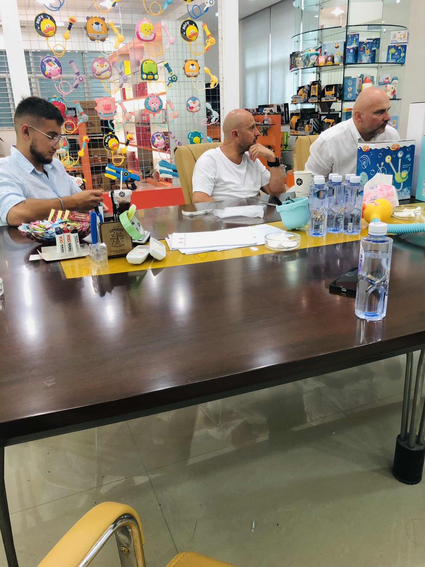 Buyer discussing toy samples with a trade team