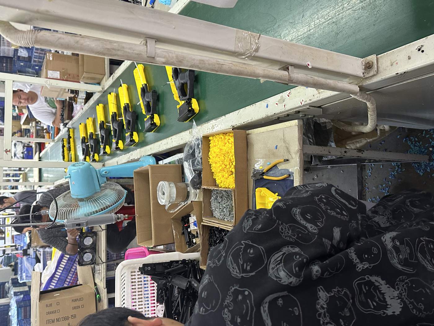Chenghai production line with workers assembling plastic toys